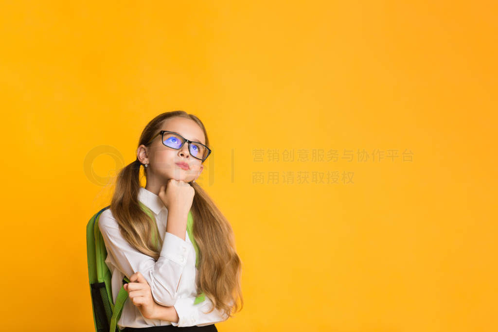 Elementary Student Girl Thinking With Hand On Chin, Yellow Backg