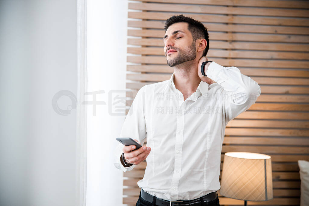 Elegant man with smartphone at home stock photo