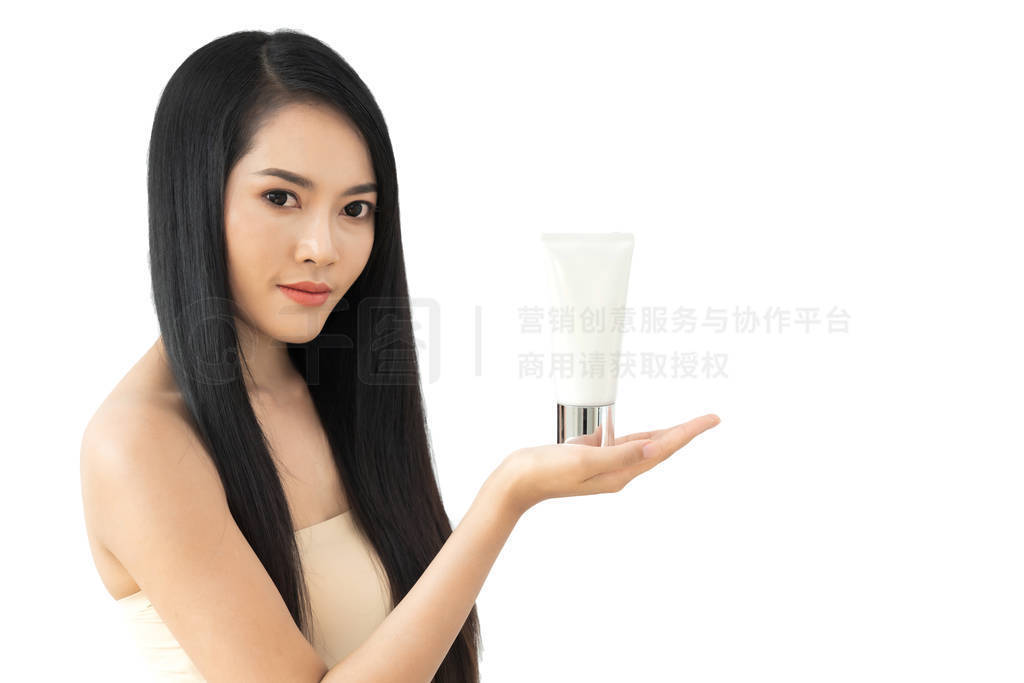 Beautiful young woman showing skincare products presenting with