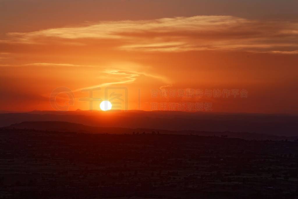 Sunset with mountain silhouette and clouds