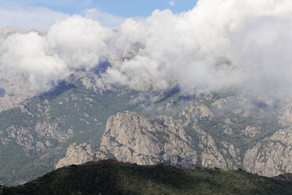 Mountains with clouds in central Corsica, France.