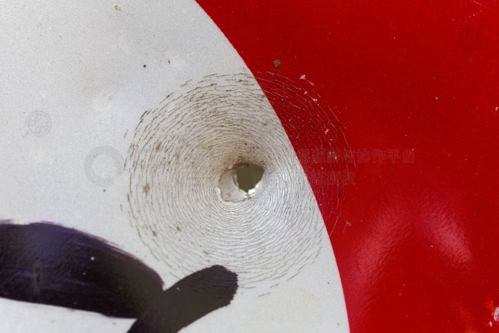 Bullet hole on a street sign.