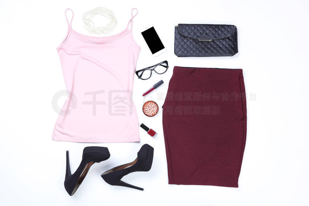 Modern women's clothes with accessories and makeup cosmetics on