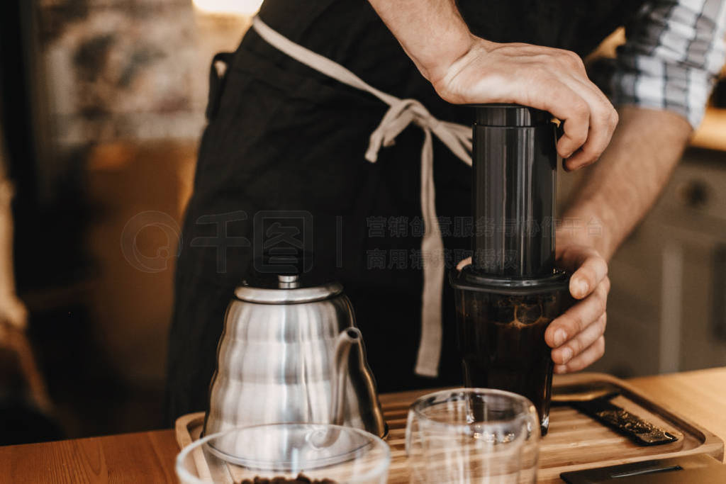 Professional barista preparing coffee in aeropress, alternative