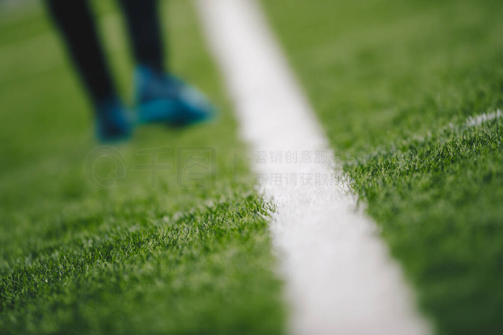 Sports grass field pitch and white sideline. Sports player walki