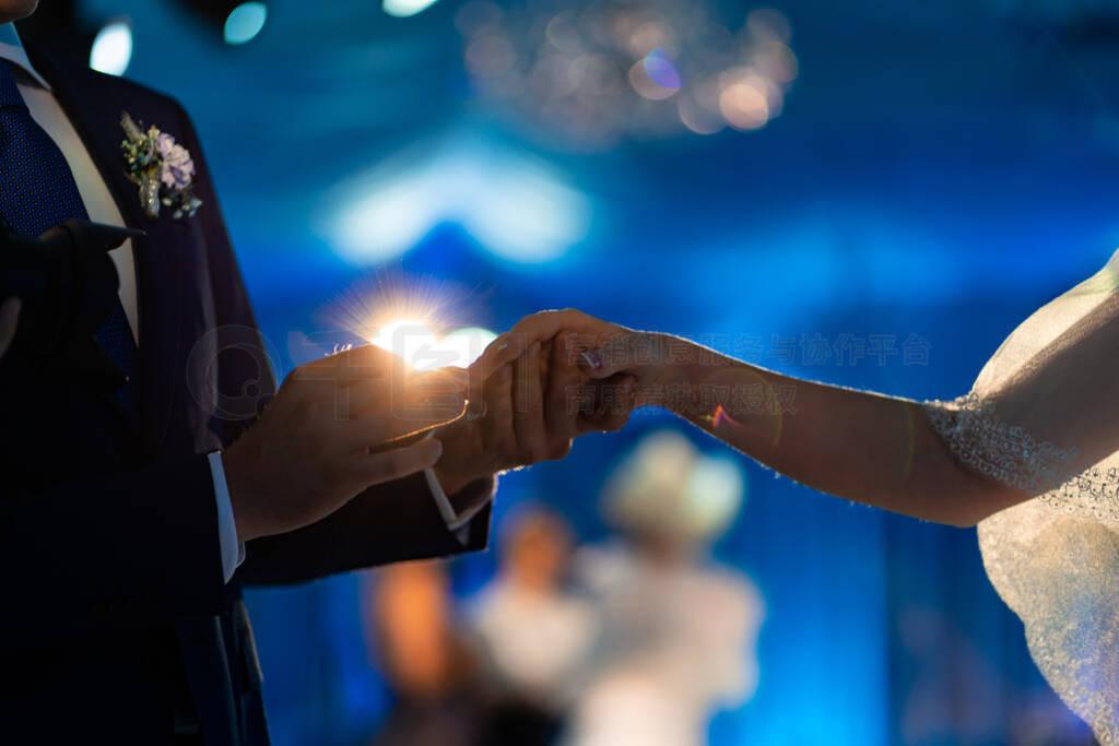 the bride and groom put on each other rings.