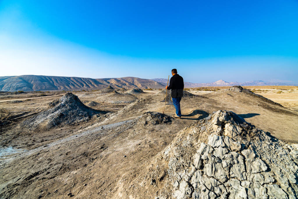 Mud volcano with tourist in background in gobustan national park