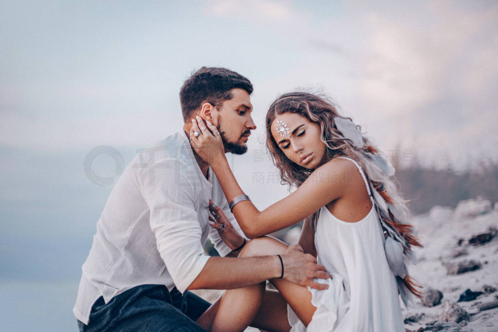 beautiful young couple on the beach at sunset.