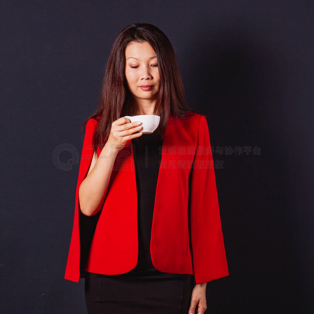 Elegant confident asian woman looks in cup of coffee, beautiful