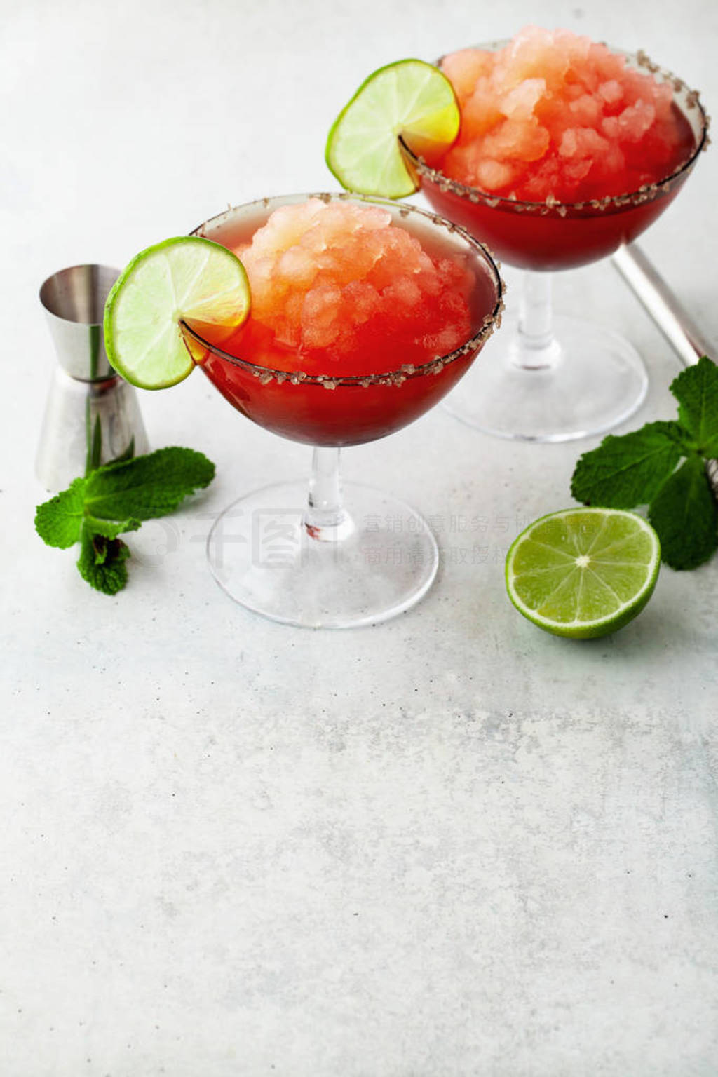 Red Frozen Margarita, refreshing cocktail on the table and lime