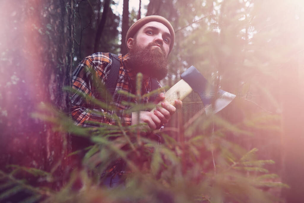 A bearded lumberjack with a large ax