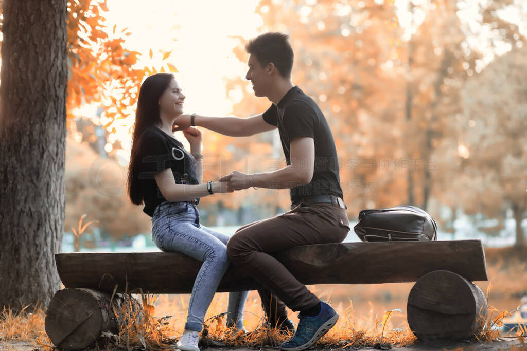 Young couple on a walk in autumn park