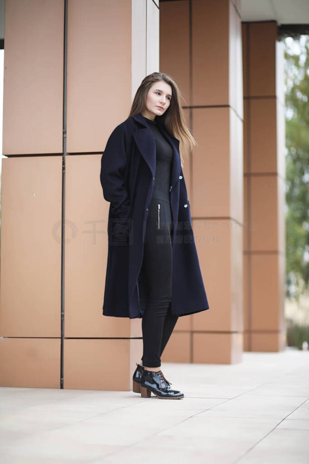Beautiful girl in a coat in business downtown