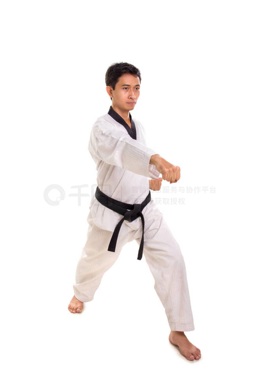 Male martial artist right straight punch, full length shot