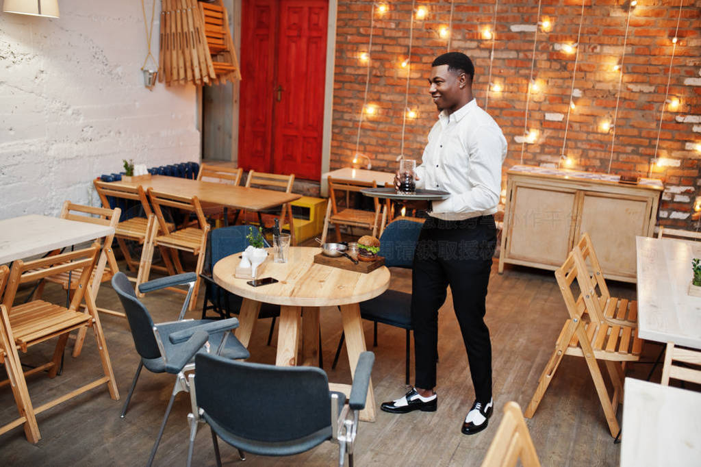 Young african american waiter man hold tray with soda drink and