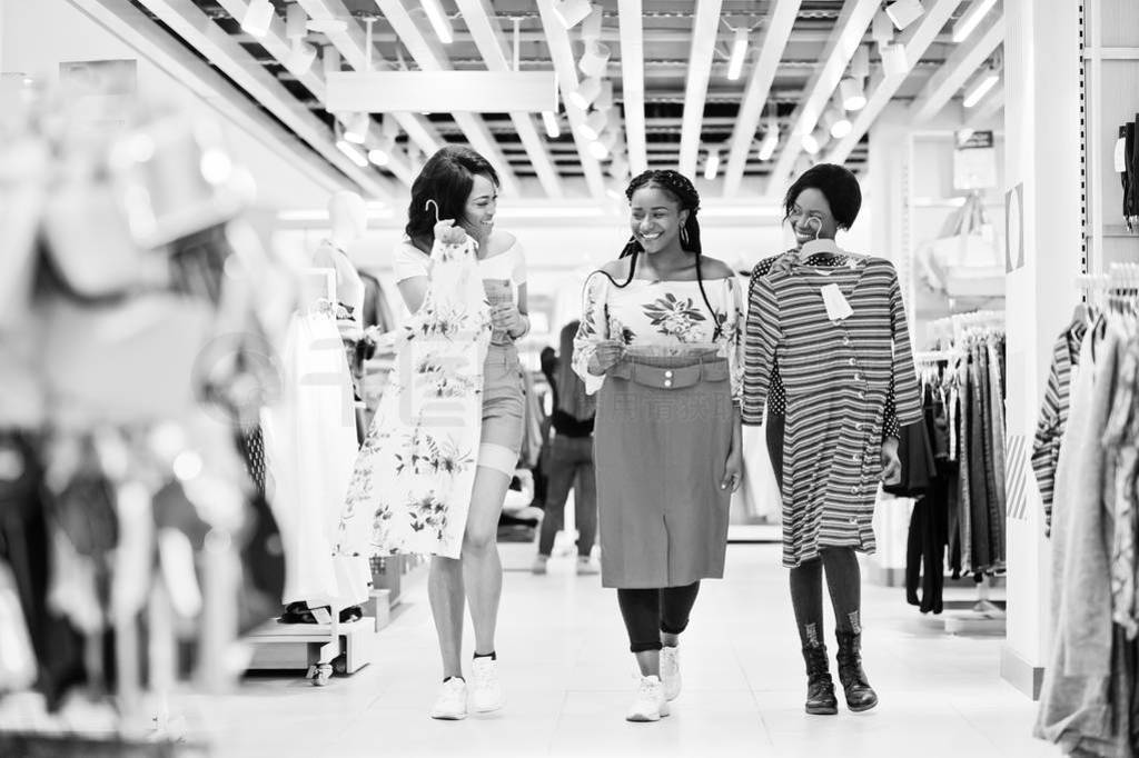 Three african woman choosing clothes at store. Shopping day.