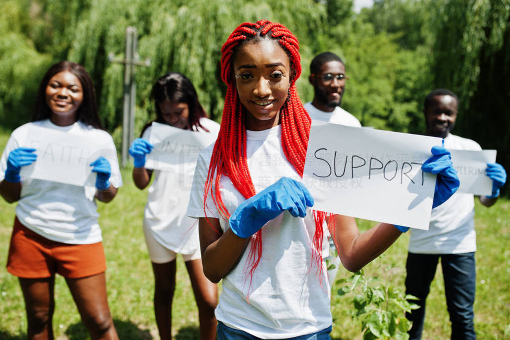 Group of happy african volunteers hold blank board with support