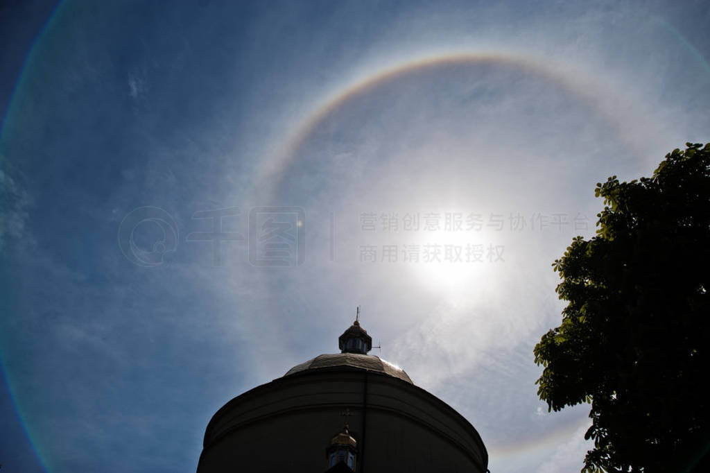 Fantastic beautiful sun halo phenomenon up the church, circular