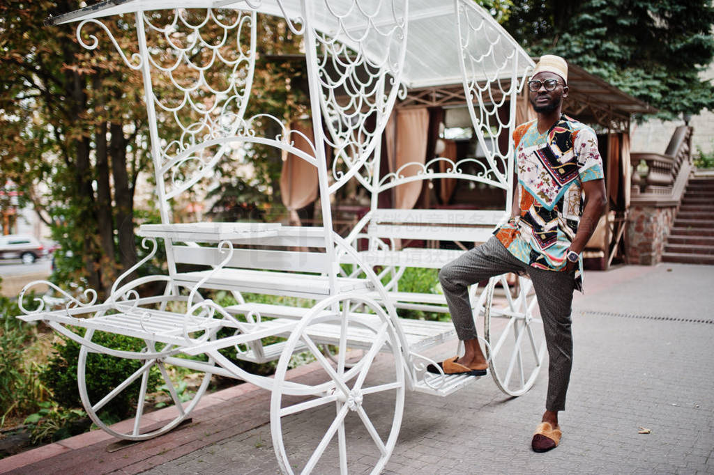 Handsome afro american man wearing traditional clothes, cap and