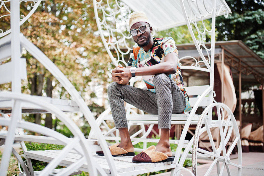 Handsome afro american man wearing traditional clothes, cap and