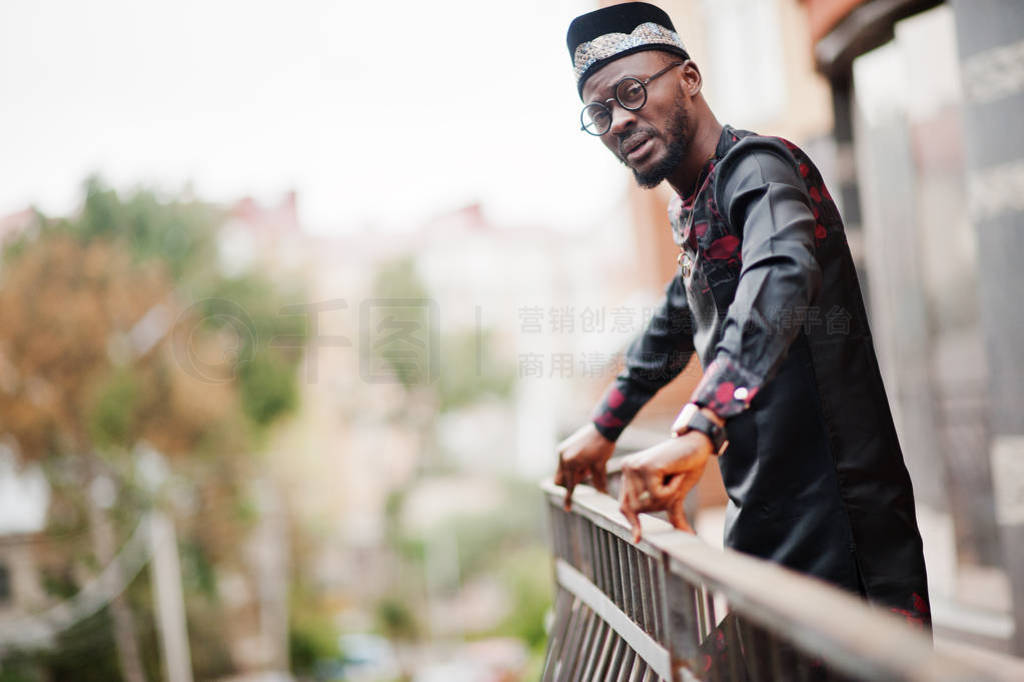 Handsome afro american man wearing traditional clothes, cap and