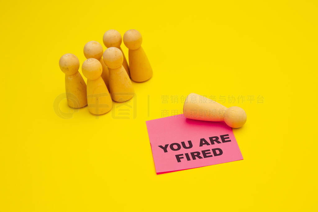 Wooden pawns near pink sticky note with phrase