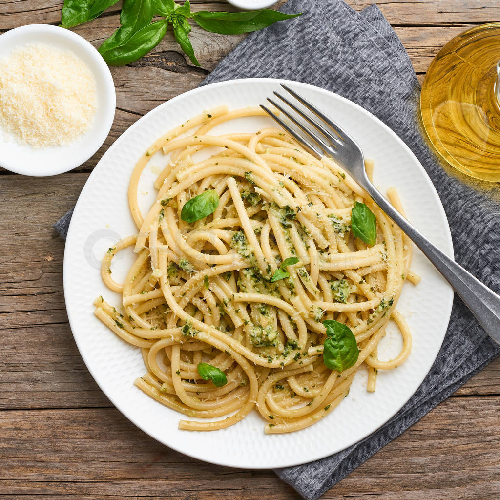 Pesto spaghetti pasta with basil, garlic, pine nuts, olive oil.