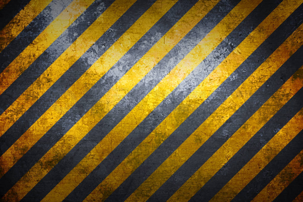warning sign banner. yellow and black on metal plate.