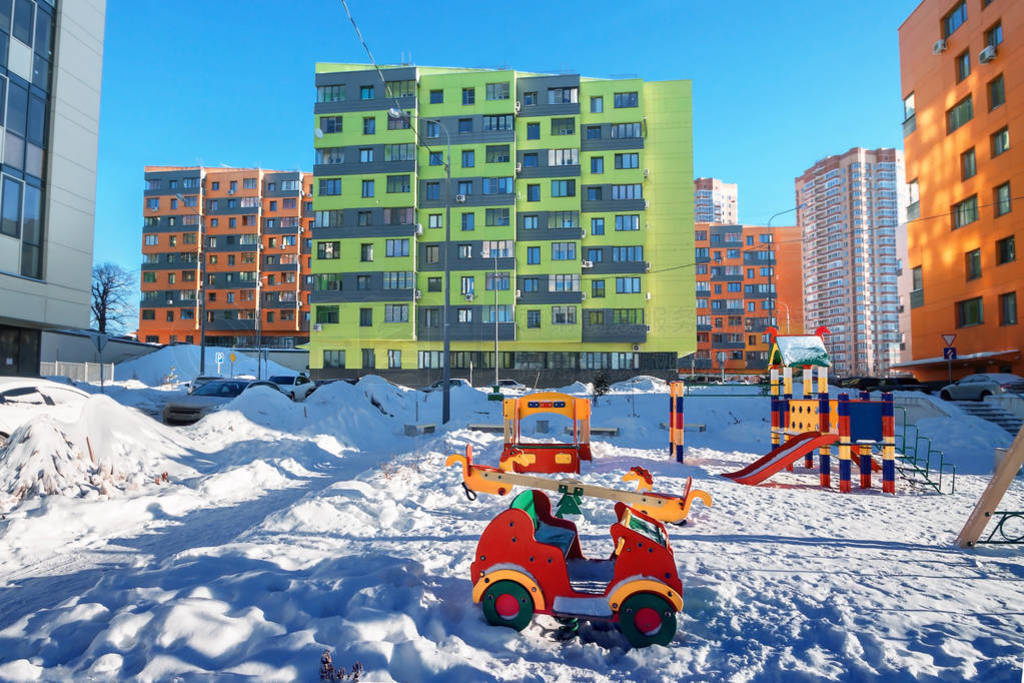 Empty snow children playground and house building exterior mixed