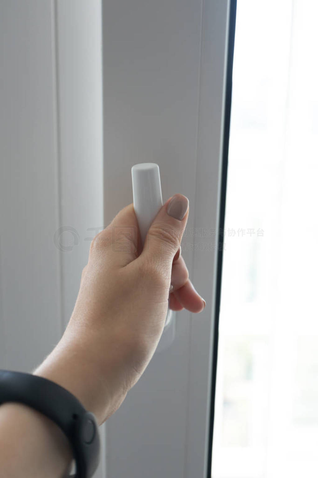 Woman closes plastic pvc modern window will keep the warmth in,