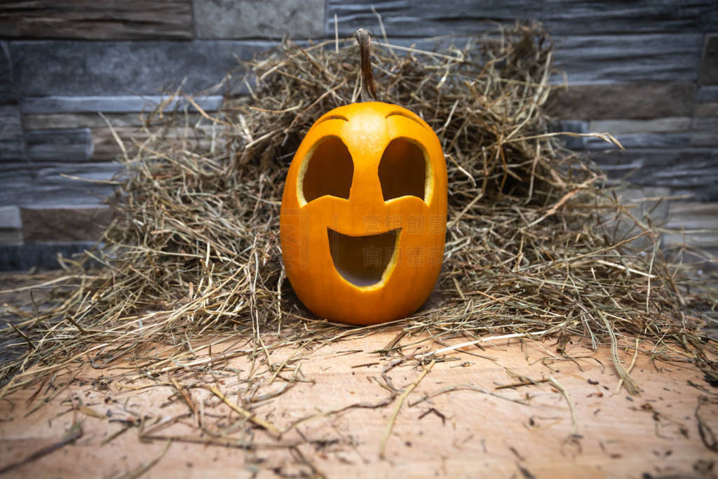 Yellow and happy smiling pumpkin. Halloween symbol on a gray sto