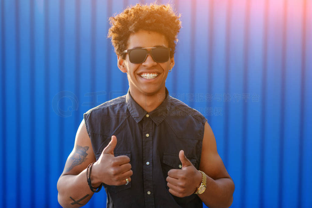Trendy black guy showing thumbs up
