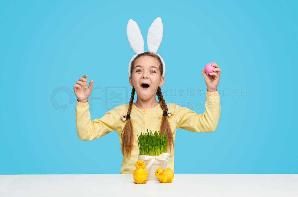 Amazed girl in bunny ears celebrating Easter