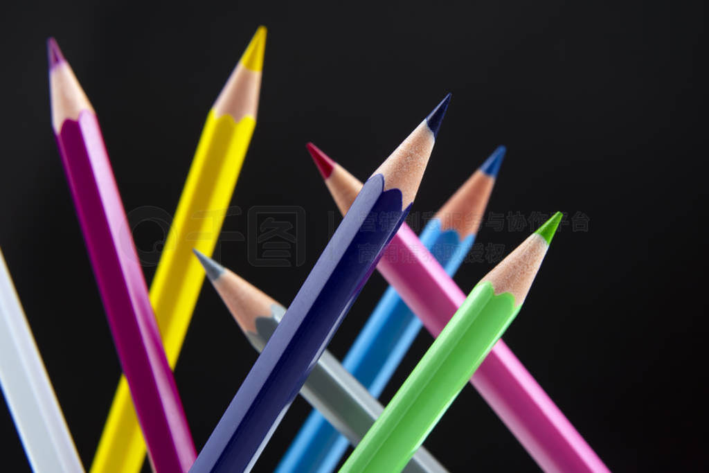 Colored pencils on a dark background. Education and creativity.