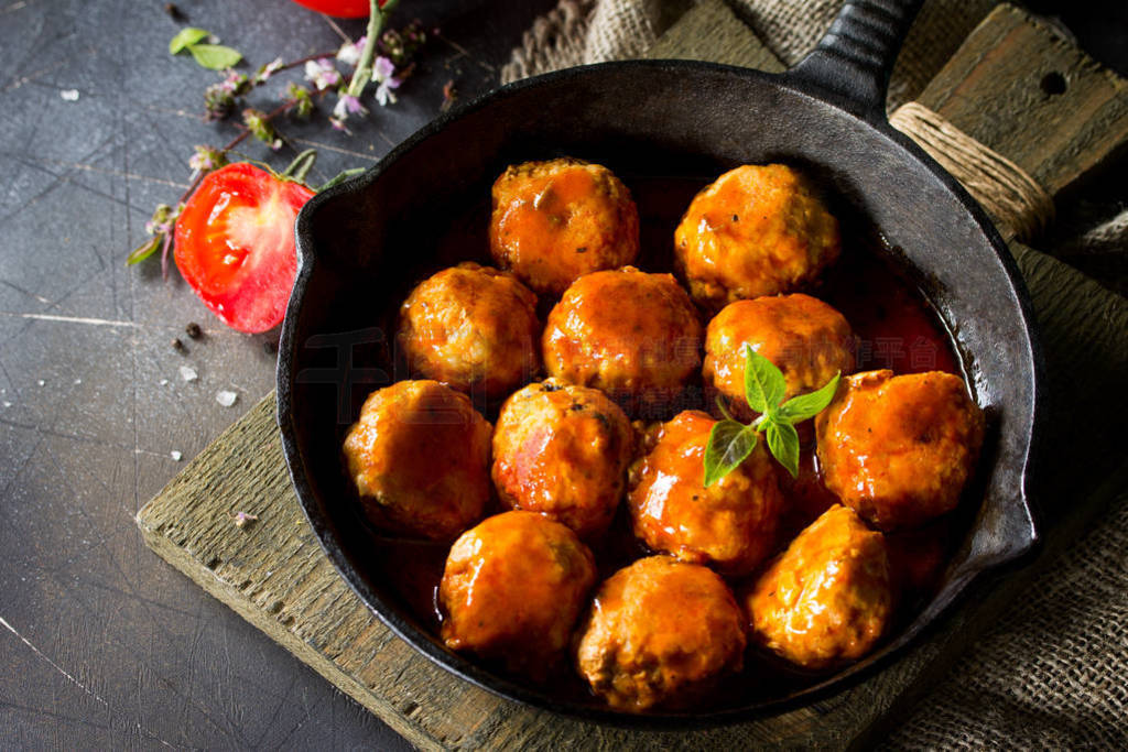 Homemade Meatballs with spices and tomato sauce in a frying pan