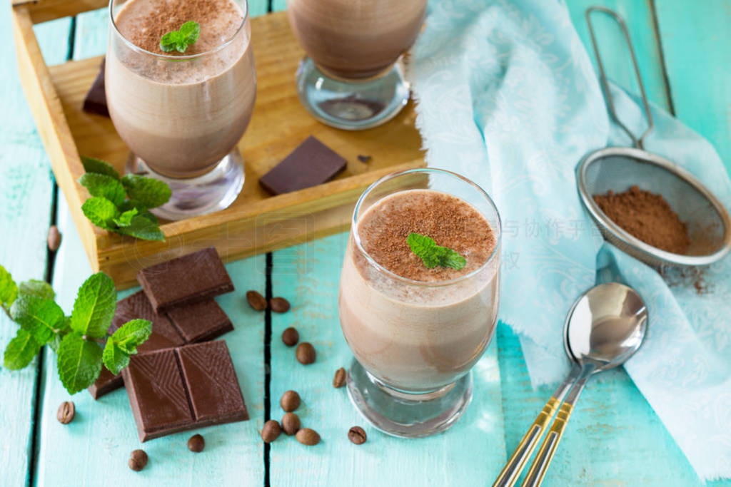 Homemade chocolate-nut mousse on the kitchen wooden background.