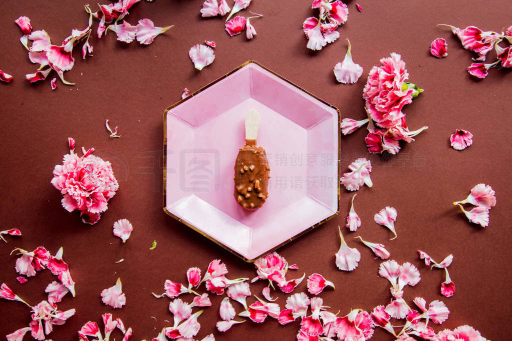 Chocolate ice-cream on plates with dianthus petals