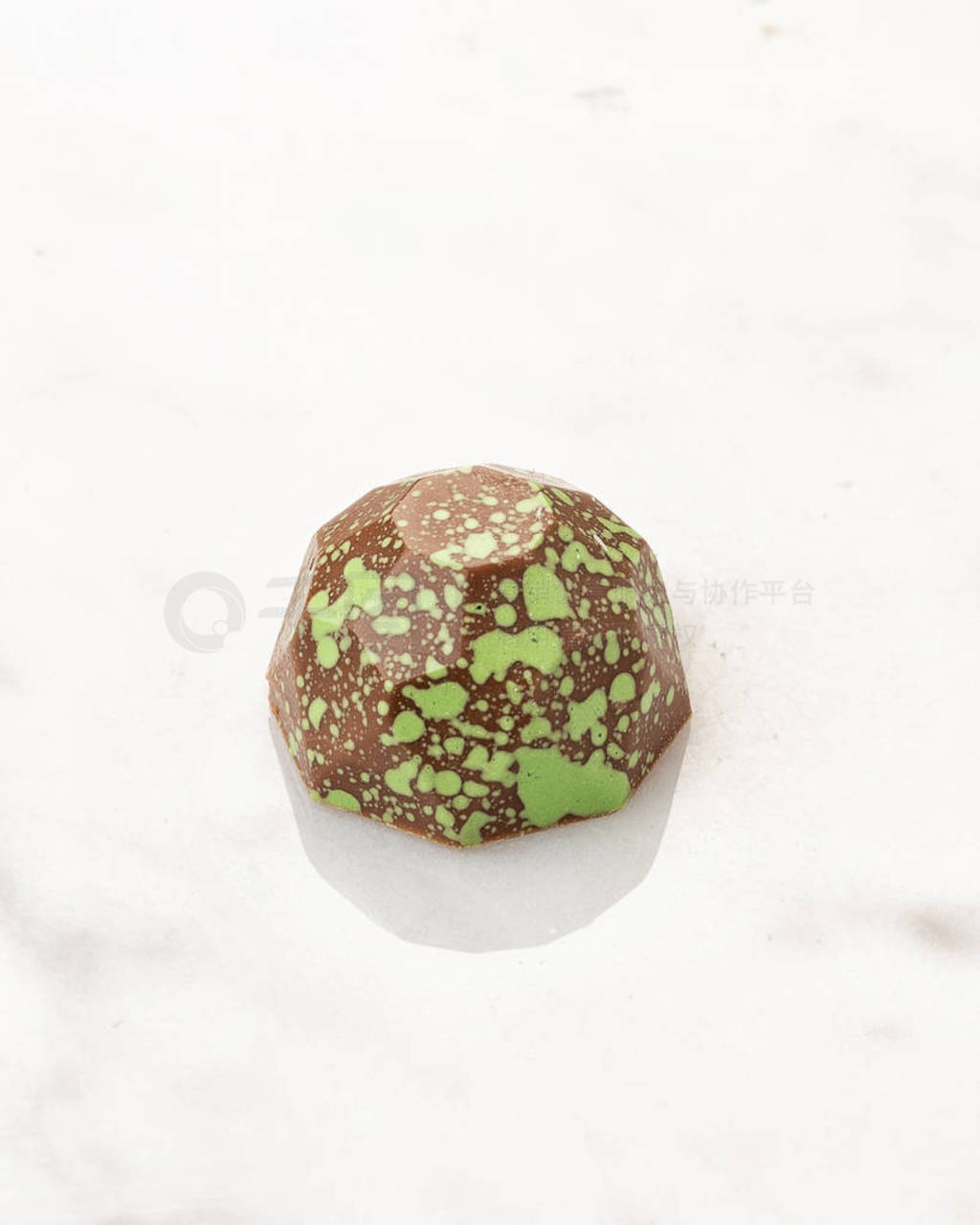 Exclusive handcrafted chocolate candy on white marble background