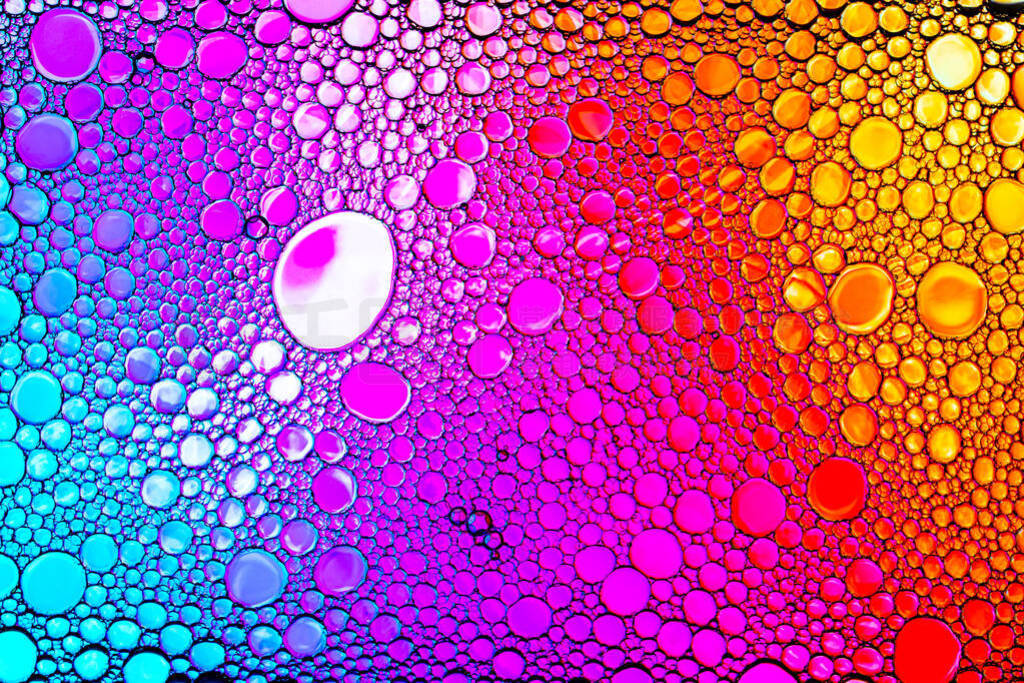 Colorful drops of oil on the water. Rainbow or spectrum colored