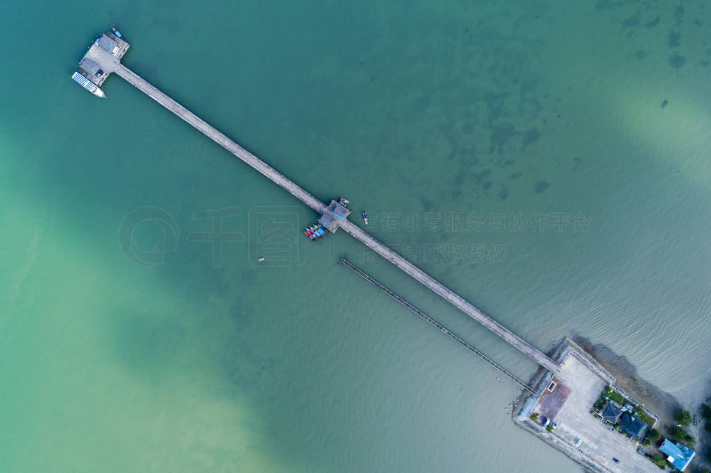 Aerial top view drone shot of bridge with long tail boats