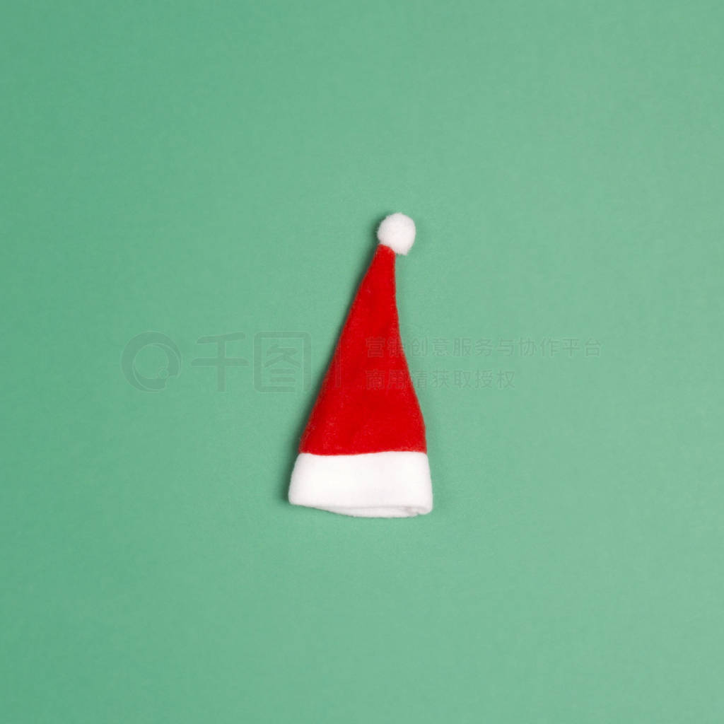 Small santa hat on green background.