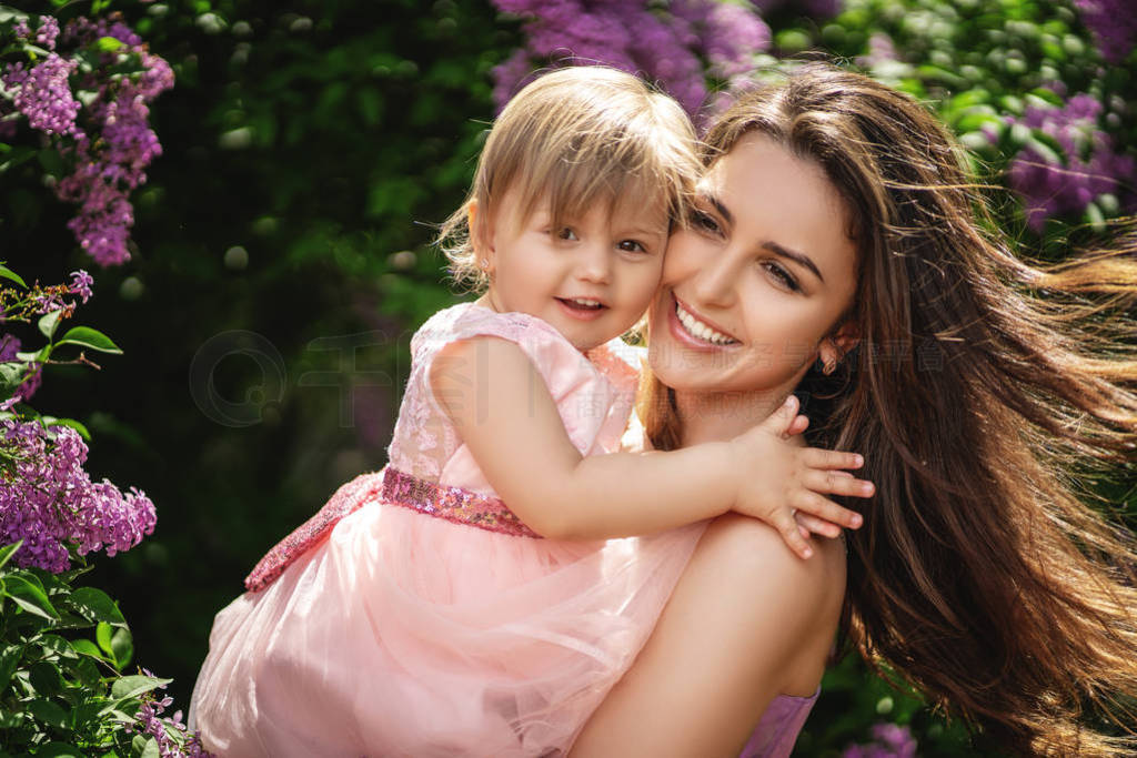 Lifestyle portrait mom and daughter in happiness at the outside