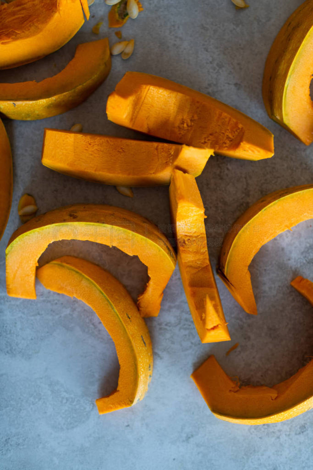 raw, cleaned pumpking slices with seed around it. ready to cook