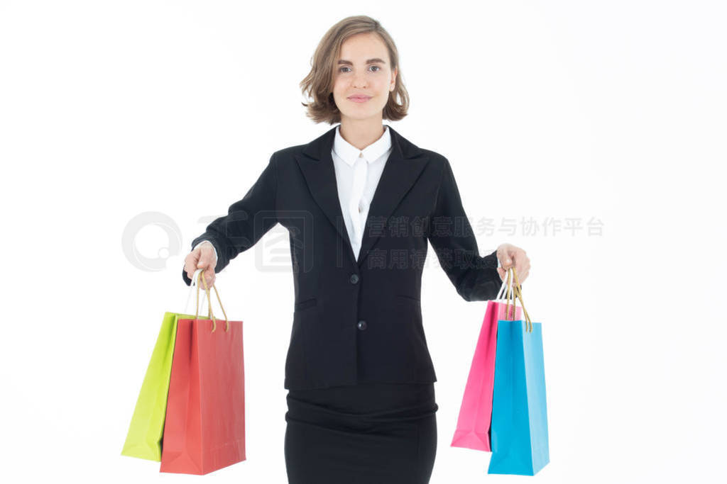 Portrait of young business woman holding shopping bags on white