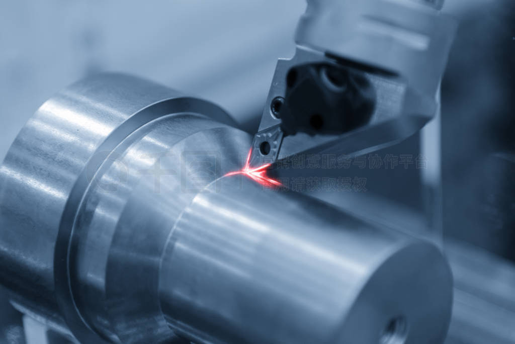 Close-up scene of the CNC lathe machine cutting the metal shaft