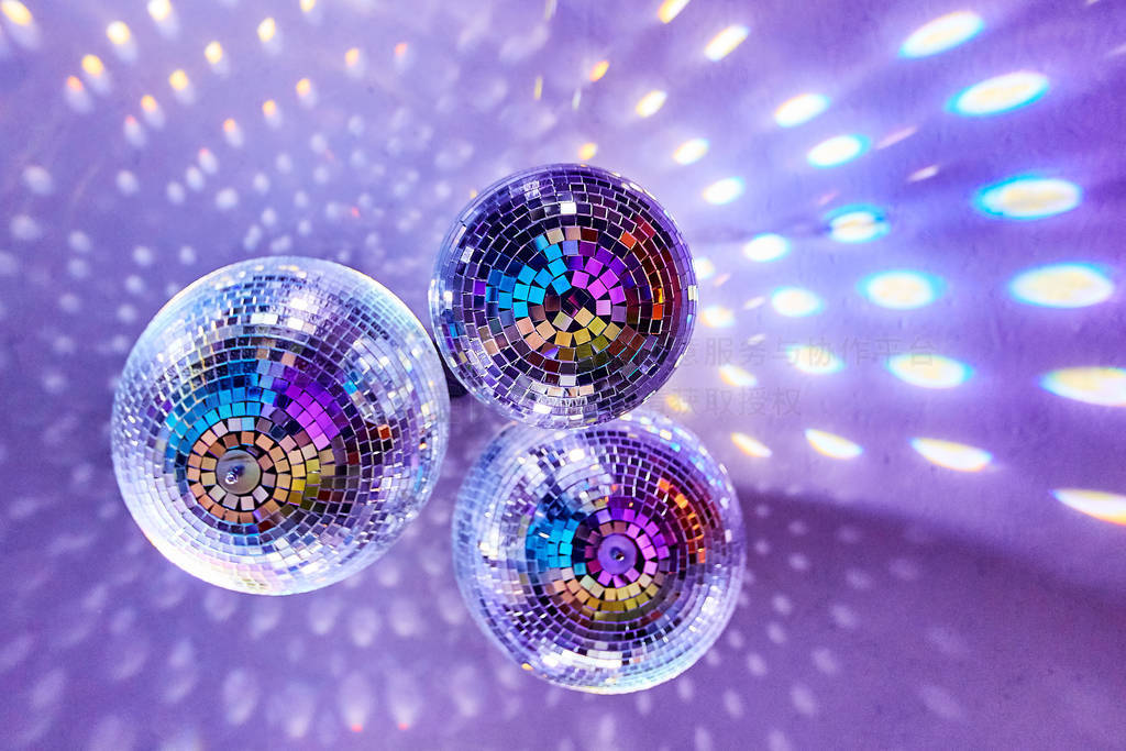 Disco balls with mirror reflections and lights at a night party