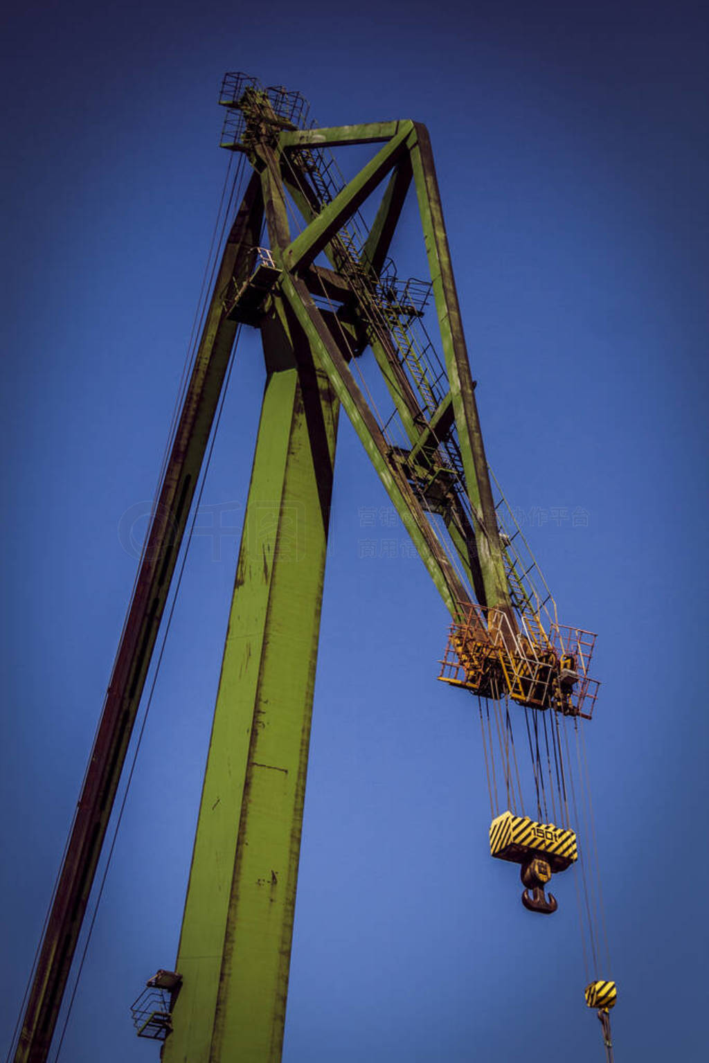 Green single boom shipyard crane