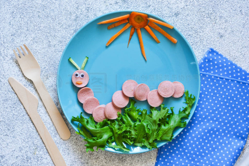 Lunch for children. Sausage caterpillar with salad for kids