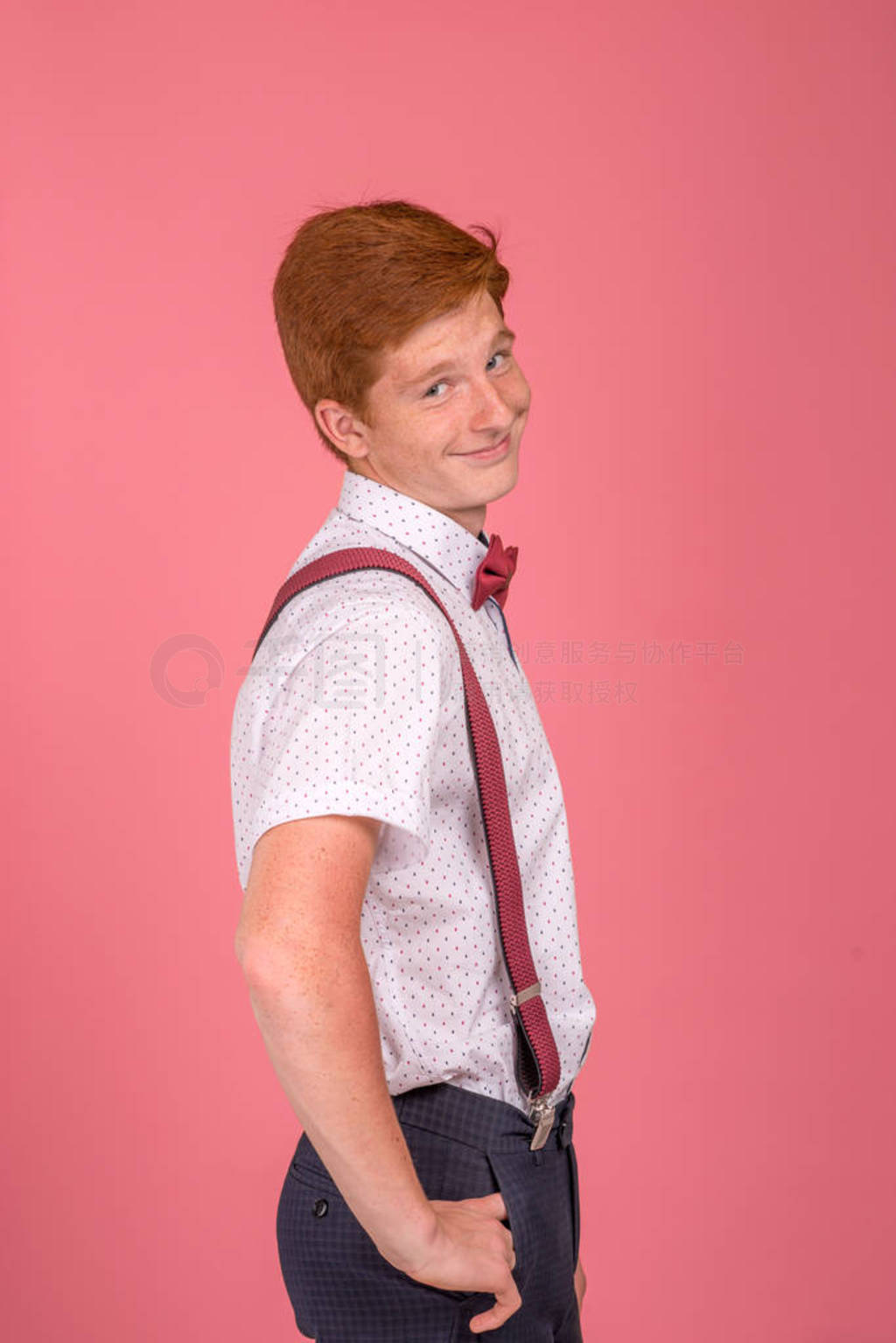 Studio shirt of a stylish red-haired young smiling redhair man