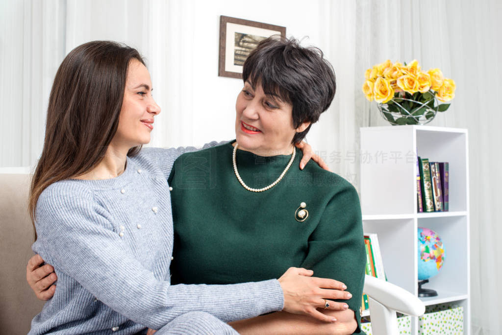 Mom and adult daughter spending time together at home.